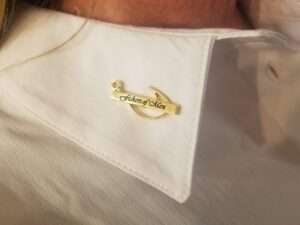 Fishers on men gold pin on white shirt