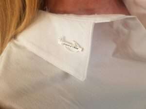 Fishers on men silver pin on white shirt